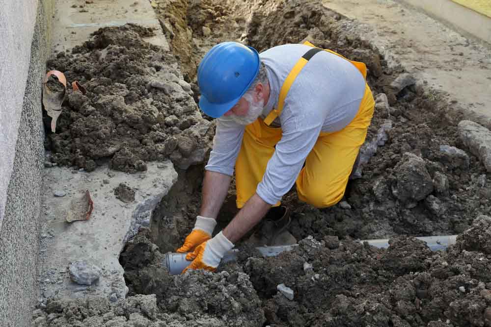 plumber repairing damaged sewer line Kennesaw, GA