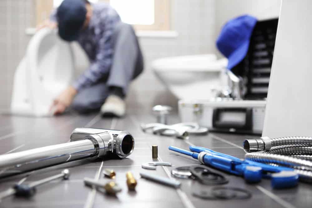 plumber at work in a bathroom Roswell GA