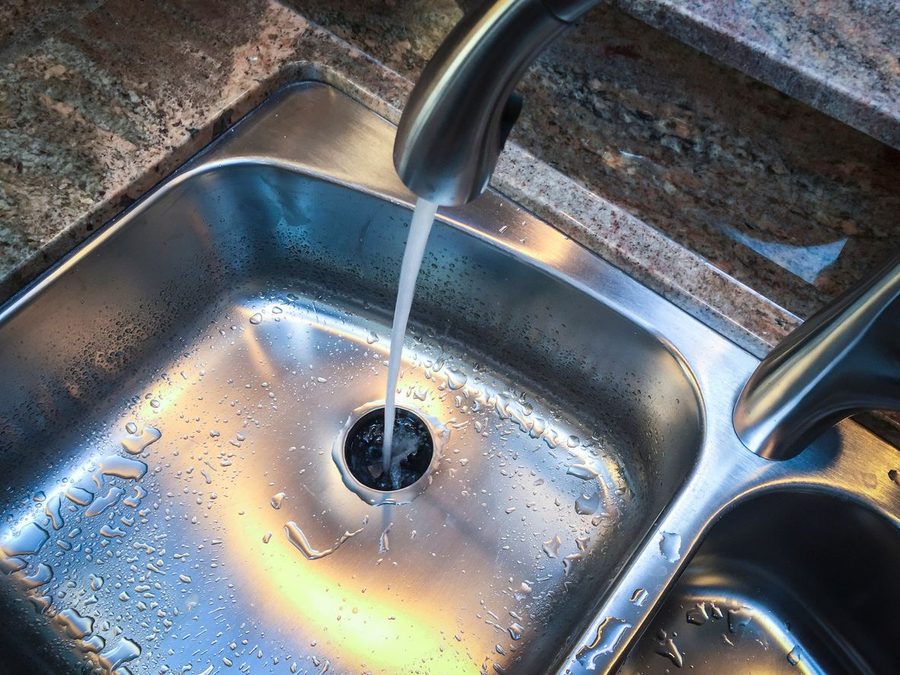 Kitchen sink with water flowing down the drain